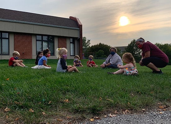 Outside with masks, learning